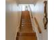 Wooden staircase leading upwards with a railing, a clock and decorative molding at 10 Toms Turnaround Cir, Edisto Island, SC 29438