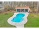 Aerial view of the backyard pool featuring a concrete surround, a cabana, and mature landscaping surrounding the area at 1012 Denali Ct, Summerville, SC 29483