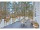 Back deck featuring white wicker furniture and steps leading down to backyard and is surrounded by trees at 1012 Denali Ct, Summerville, SC 29483
