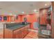 A partial view of the basement bar with granite countertops, appliances, wooden cabinets, and wine storage at 1012 Denali Ct, Summerville, SC 29483
