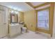 Bright bathroom with neutral walls, white vanity with a mirror, and a window with blinds at 1012 Denali Ct, Summerville, SC 29483