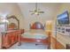 Bedroom with antique wooden furniture, including a dresser and bed, with a flat screen TV on the wall at 1012 Denali Ct, Summerville, SC 29483