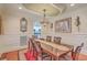 Elegant dining room featuring a large table with seating for six, a decorative chandelier, and wainscoting on the walls at 1012 Denali Ct, Summerville, SC 29483