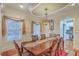 Elegant dining room featuring a large table with seating for six, a decorative chandelier, and wainscoting on the walls at 1012 Denali Ct, Summerville, SC 29483