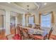 Elegant dining room featuring a large table with seating for six, a decorative chandelier, and wainscoting on the walls at 1012 Denali Ct, Summerville, SC 29483