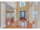 Grand foyer with soaring ceilings, hardwood floors, elegant columns, and a beautifully designed front door with lots of natural light at 1012 Denali Ct, Summerville, SC 29483