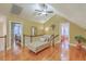 Hallway on upper level with a chaise lounge, wood floors, and views into bedrooms at 1012 Denali Ct, Summerville, SC 29483