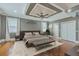 This main bedroom features a tray ceiling, ceiling fan, neutral walls, and wood flooring at 1012 Denali Ct, Summerville, SC 29483