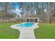 Backyard kidney-shaped pool featuring a concrete surround and a cabana surrounded by a tall, mature tree line at 1012 Denali Ct, Summerville, SC 29483