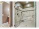 Walk-in shower with a built-in bench, glass doors, tile surround, and a shower head at 1012 Denali Ct, Summerville, SC 29483
