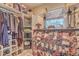 Walk-in closet with shelves for shoes, handbags, and clothes with a window at 1012 Denali Ct, Summerville, SC 29483