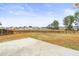Large grassy backyard with a patio, framed by a wooden fence and lush trees at 106 Terrapin Cir, Summerville, SC 29483
