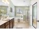 A bathroom with double vanities, large mirror, a standalone tub, tiled floors, and a separate shower at 106 Terrapin Cir, Summerville, SC 29483