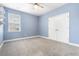 A simple bedroom with blue walls, a ceiling fan, a window and a closet with bi-fold doors at 106 Terrapin Cir, Summerville, SC 29483