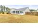 Back exterior of house with a screened porch, patio, fenced yard, and green siding at 106 Terrapin Cir, Summerville, SC 29483