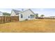 Back exterior of house with a screened porch, patio, fenced yard, and green siding at 106 Terrapin Cir, Summerville, SC 29483