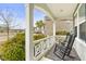 Inviting front porch with rocking chairs, decorative rug, and view of the neighborhood at 106 Terrapin Cir, Summerville, SC 29483