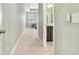 A hallway with carpet, leading into the main bedroom and an attached bathroom with double vanities at 106 Terrapin Cir, Summerville, SC 29483