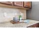 Granite countertops and tiled backsplash with dark wood cabinets in the kitchen at 106 Terrapin Cir, Summerville, SC 29483