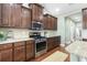 Updated kitchen with stainless steel appliances, granite countertops, and dark wood cabinetry at 106 Terrapin Cir, Summerville, SC 29483