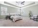 A spacious bedroom with carpet, trey ceilings, ceiling fan, and large windows with stylish window treatments at 106 Terrapin Cir, Summerville, SC 29483