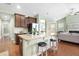 Open floorplan with kitchen, dining, and living areas, hardwood floors, and vaulted ceilings at 106 Terrapin Cir, Summerville, SC 29483
