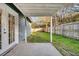 View of the fenced backyard from the covered patio with a concrete floor and blue siding at 1060 Oakcrest Drive, Charleston, SC 29412
