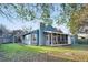 Backyard with grassy area, storage shed, screened porch, and exterior features at 1060 Oakcrest Drive, Charleston, SC 29412