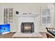 Cozy fireplace with white mantel, decorative screen, and tile surround, flanked by shuttered windows at 1060 Oakcrest Drive, Charleston, SC 29412