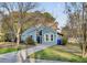 Inviting blue home with a well-kept front yard and a paved driveway at 1060 Oakcrest Drive, Charleston, SC 29412