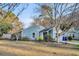 Charming blue home featuring a well-maintained front yard and inviting landscaping at 1060 Oakcrest Drive, Charleston, SC 29412