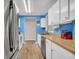 Functional kitchen with white cabinets, wood countertops, and stainless steel appliances at 1060 Oakcrest Drive, Charleston, SC 29412
