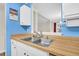 Kitchen area shows a double basin stainless steel sink, neutral wood countertops, and blue walls at 1060 Oakcrest Drive, Charleston, SC 29412