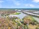 Stunning aerial view of homes nestled among vibrant fall foliage with a scenic river running through the landscape at 1106 Mccrae Dr, Moncks Corner, SC 29461