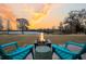 Outdoor fire pit with seating next to the lake at 1106 Mccrae Dr, Moncks Corner, SC 29461