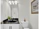 Bathroom featuring a sleek black countertop, updated fixtures, white cabinetry, and framed artwork at 1106 Mccrae Dr, Moncks Corner, SC 29461