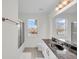 Bright bathroom featuring double windows, dark marble counters, and modern fixtures at 1106 Mccrae Dr, Moncks Corner, SC 29461