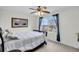 Inviting bedroom with ceiling fan, dark wood furniture and serene lake view at 1106 Mccrae Dr, Moncks Corner, SC 29461