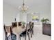 Formal dining room featuring wooden table with seating for six, and a view to a sunroom with a ceiling fan at 1106 Mccrae Dr, Moncks Corner, SC 29461