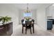 Formal dining room featuring chandelier, decorative molding, and a large window overlooking the backyard at 1106 Mccrae Dr, Moncks Corner, SC 29461