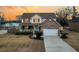 Charming two-story home with brick facade and welcoming front porch, reflecting sunset at 1106 Mccrae Dr, Moncks Corner, SC 29461