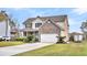 Beautiful two-story home with brick accents, a two-car garage, and a well-manicured front yard at 1106 Mccrae Dr, Moncks Corner, SC 29461