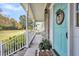Inviting front porch with brick accents, white columns, and a charming blue front door at 1106 Mccrae Dr, Moncks Corner, SC 29461