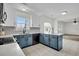 Bright kitchen with an island, tiled flooring, modern appliances, and seamless transition to sunroom at 1106 Mccrae Dr, Moncks Corner, SC 29461