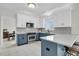 Modern kitchen with white cabinets, contrasting blue island, stainless steel appliances, and white countertops at 1106 Mccrae Dr, Moncks Corner, SC 29461