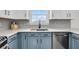 Stylish kitchen features blue cabinets, white countertops and backsplash, and stainless steel appliances at 1106 Mccrae Dr, Moncks Corner, SC 29461