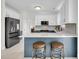 Spacious kitchen with white countertops, blue island with seating, stainless steel appliances and tile floor at 1106 Mccrae Dr, Moncks Corner, SC 29461