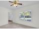 Bright living room featuring neutral carpet, white walls, and a window with views of the landscaped front yard at 1106 Mccrae Dr, Moncks Corner, SC 29461
