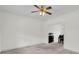 Bright living room featuring neutral carpet, white walls, and a modern ceiling fan with light fixture at 1106 Mccrae Dr, Moncks Corner, SC 29461