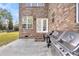 View of back patio with double doors, stainless grill, and outdoor seating, creating a perfect space for outdoor dining at 1106 Mccrae Dr, Moncks Corner, SC 29461